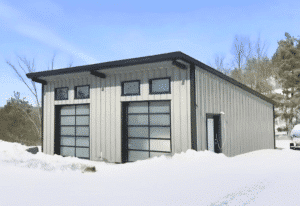A contemporary steel garage with two large glass-paneled garage doors